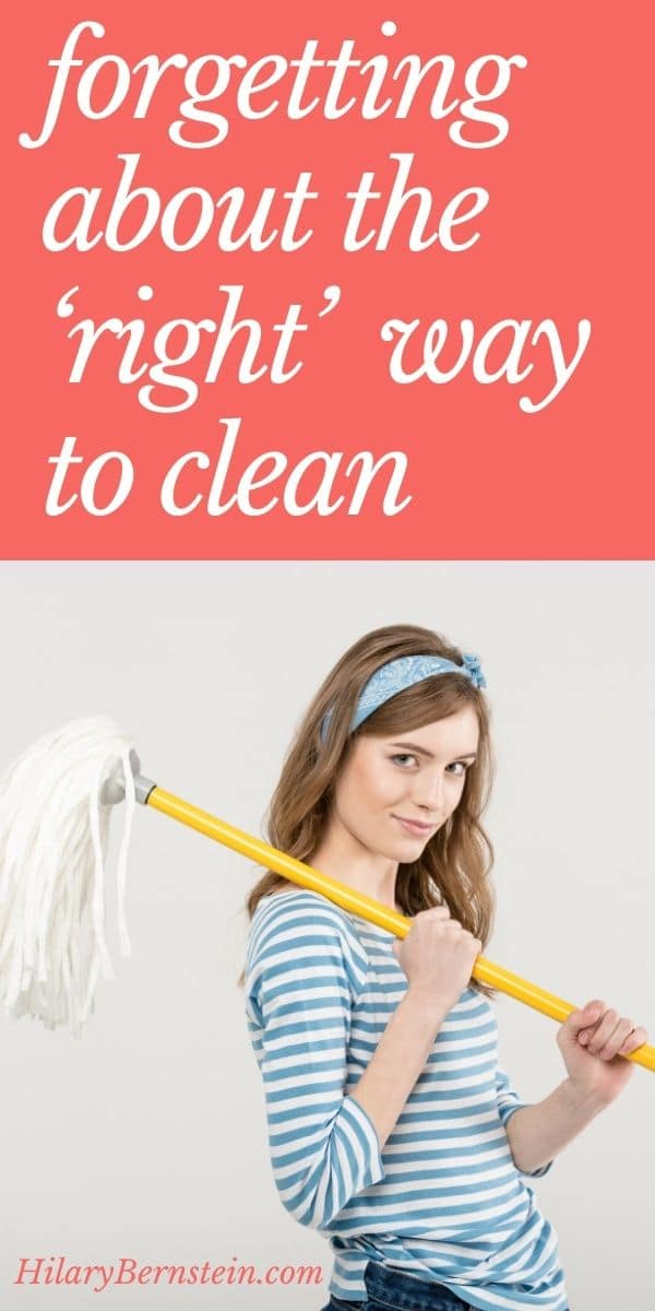 Woman stands holding mop