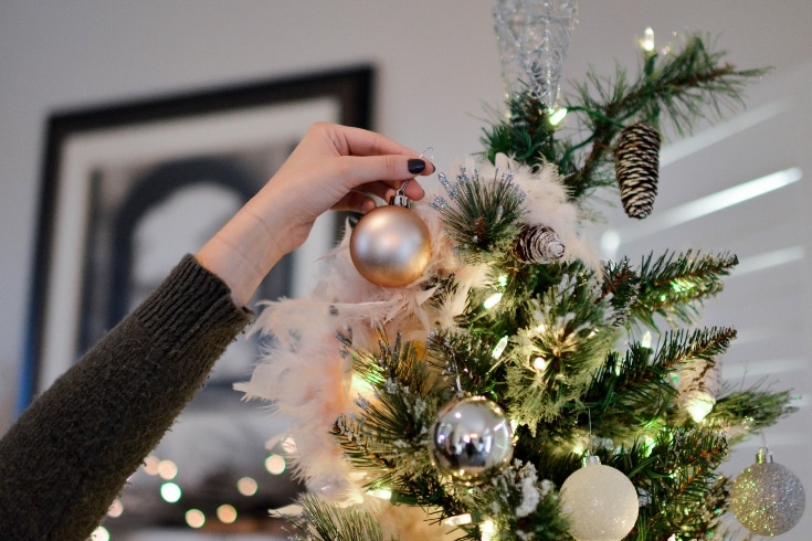 Woman decorates Christmas tree