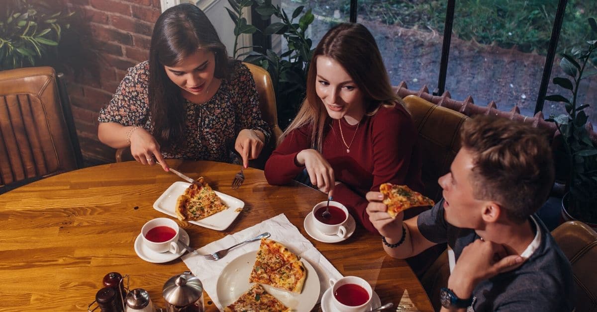 A group of friends sit around a table