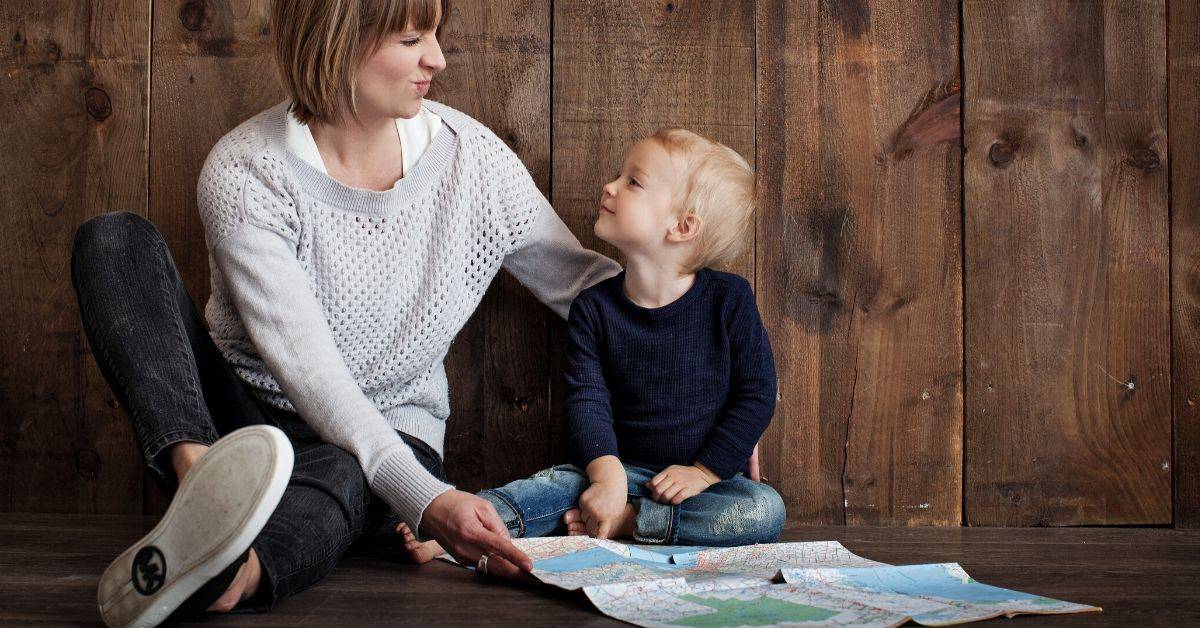 Mom and toddler son look at a map together