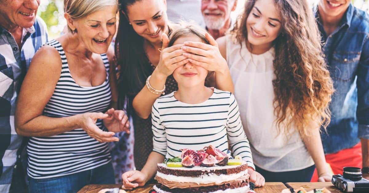 Girl prepares to blow candles out on her birthday cake