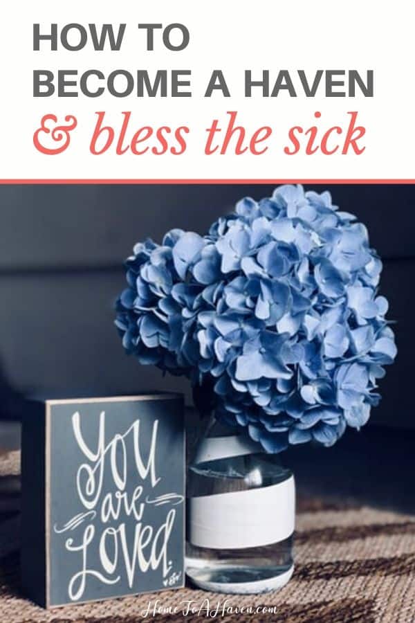 Vase of blue hydrangeas next to a sign that says, "You Are Loved"