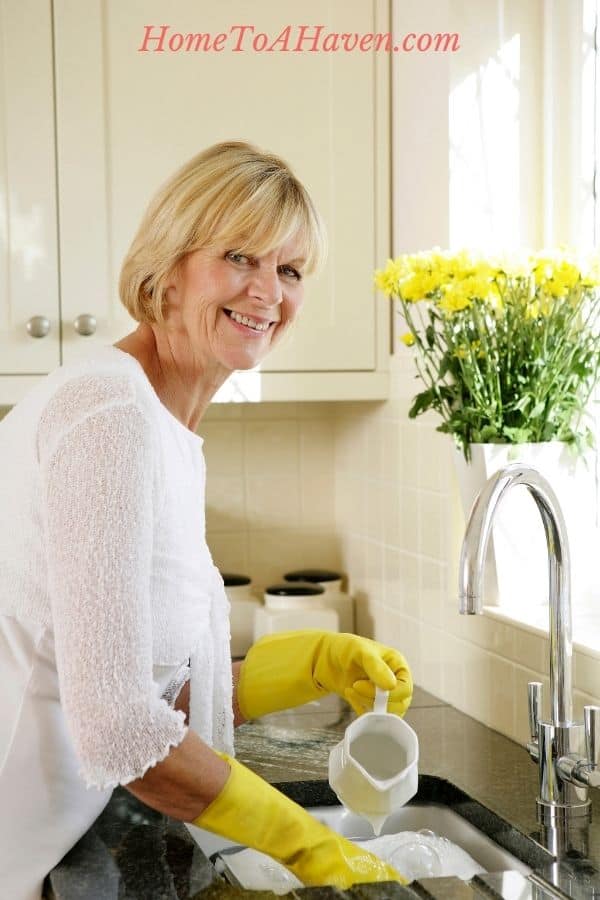 Woman washes dishes by hand